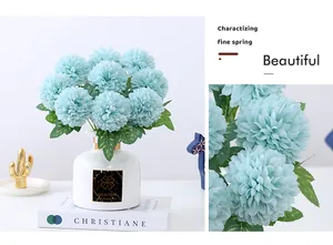 Close up view of artificial light blue pompon chrysanthemum bouquet in white vase detail.