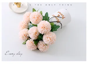 Close-up detail of artificial ping pong chrysanthemum flower bouquet in soft pink home decor.