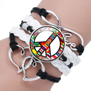 Close-up of a multilayer braided bracelet featuring a colorful peace sign and love charm