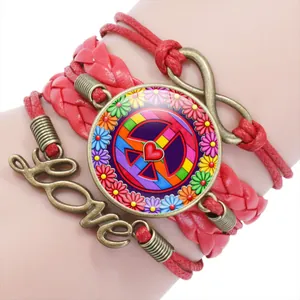 Close-up of red woven multilayer bracelet with colorful peace sign and love charm