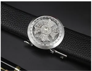 Close-up detail of the luxury rhinestone crystal circular metal buckle on black leather belt.