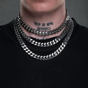 Detailed view of triple layered thick silver Cuban link chains on male model neck