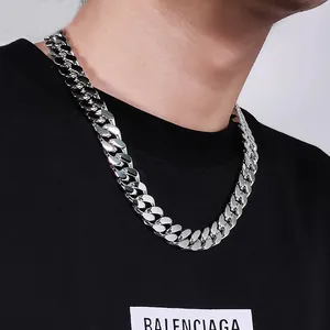 Detailed macro view of a heavy-duty polished stainless steel Cuban chain necklace