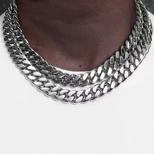 Detailed view of heavy duty polished stainless steel Cuban link necklaces on a male neck