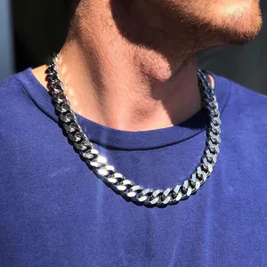 Close-up of men's heavy polished silver stainless steel Cuban link necklace worn on neck