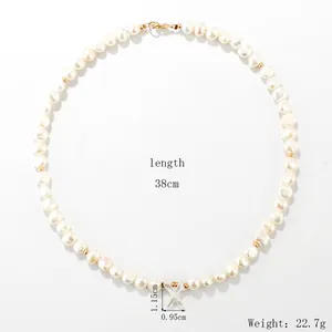 Freshwater pearl necklace with shell letter X pendant and short choker length 38cm.