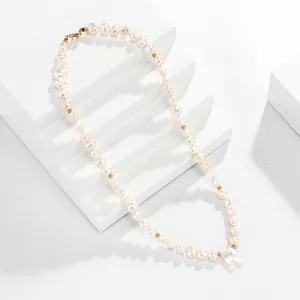 Pearl letter R necklace detail shot showing freshwater pearls and shell pendant close-up.