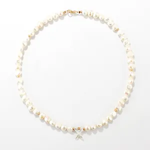 Freshwater pearl necklace featuring a mother-of-pearl shell letter pendant and gold beads.