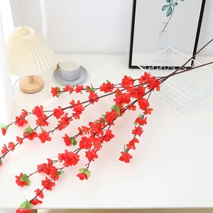 Artificial plum blossom branches for home wedding decor, vibrant red fake flower stems.