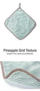 Close-up of coral fleece hand towel showing pineapple texture and checkered border