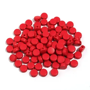 Close-up detail of vibrant red acrylic flat round beads, perfect for DIY bracelet making and crafts.