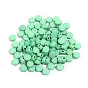 Detail view of light green flat round acrylic beads, perfect for DIY handmade bracelets and jewelry.