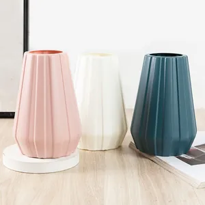 Modern geometric plastic flower vase detail, minimalist home desktop decor arrangement