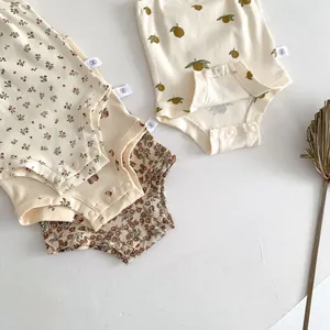 Detailed view of summer baby cotton strap rompers, cute floral and fruit prints with snap closure.