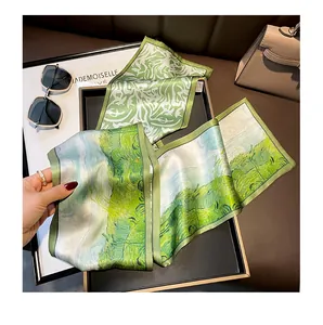 Elegant green silk ribbon scarf with artistic landscape print, perfect spring neckerchief accessory.