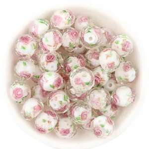 Detail shot of faceted glass millefiori beads with pink rose and gold sand, perfect for DIY jewelry.