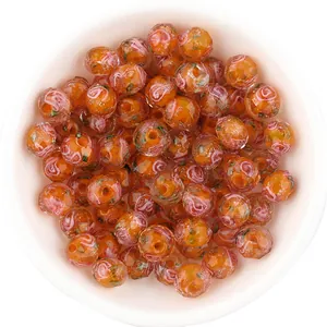 Close-up detail of Japanese millefiori glass beads with glitter and facets for DIY crafts.