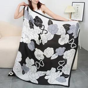 Silk feel large square scarf featuring classic black and white camellia floral pattern, elegant accessory.