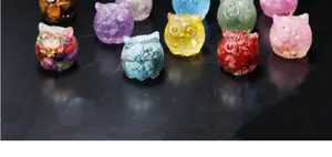 Macro view of colorful handmade resin owl figurines with embedded crystal stones