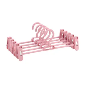 Set of 5 adjustable pink plastic pants hangers with non-slip clips for closet storage
