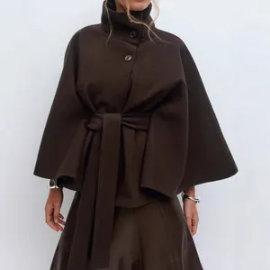 Elegant dark brown women's cape coat with stand collar, buttons, and matching waist belt