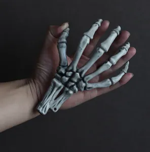 Close-up detail of a realistic plastic skeleton hand for Halloween spooky decor