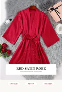 Elegant red satin robe with tie-waist and wide sleeves on luxury faux fur background
