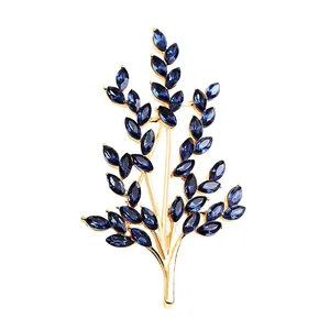 Elegant wheat branch brooch with dark blue marquise-cut crystals in gold setting