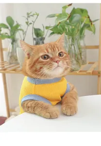Cute cat wearing a breathable yellow and blue pet vest detail view, comfortable summer clothing.