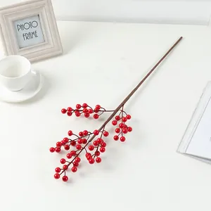 Detailed close-up of artificial red berry branch stem, vibrant winter holly holiday decor.