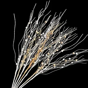 Close-up of golden and white glitter berry branches for Christmas tree decoration.