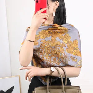 Elegant grey silk square scarf featuring luxurious gold baroque crest and scroll print design for women.