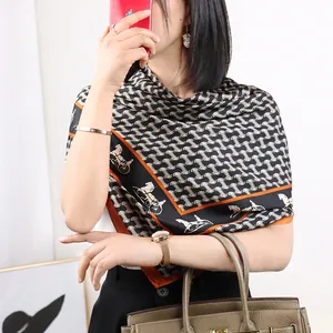 Elegant black and white silk scarf with orange border, luxury horse carriage print fashion.