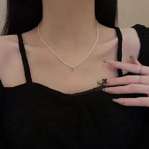 Stunning sterling silver clavicle necklace featuring a sparkling green zircon pendant for women.
