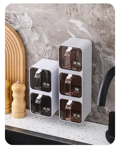 Wall-mounted seasoning box set with clear bilingual labels in a modern kitchen setting