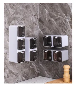 Modern wall-mounted seasoning box set with white plastic frames and dark lids.