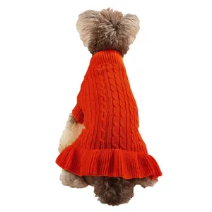 Orange cable knit dog sweater detail showing cozy texture and cute ruffled hem for small pets.