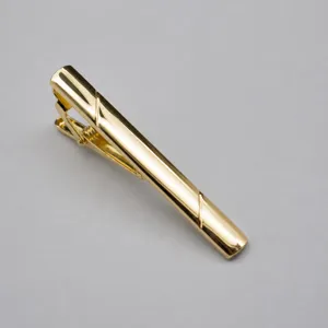 Golden metal tie clip for men, classic minimalist business suit accessory detail view.