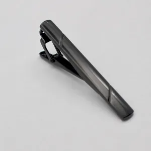 Close-up detail of the black metal tie clip, showcasing sleek lines and a minimalist business design.