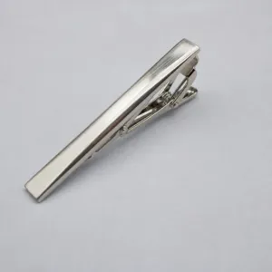 Silver metal tie clip detail view, classic minimalist bar design for men's business wear.