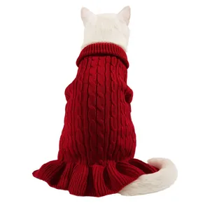 Close-up detail of the red cable knit pet sweater showing fine wool texture and ruffled hem.