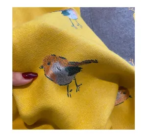 Embroidered bird pattern yellow scarf detail, soft imitation cashmere texture and fine craft display.