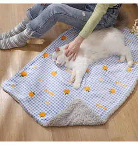 Cozy blue checkered pet mat with cute orange print and soft plush lining for cats and dogs warmth.