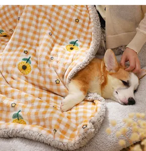 Close-up detail of cozy pet blanket with cute sunflower embroidery, soft warm plush material.