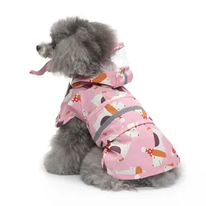 Detailed view of the pink pet raincoat featuring cute cartoon dog print and reflective strips.