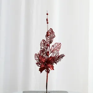 Red glitter artificial Christmas branch detail shot, festive holiday floral decor piece.