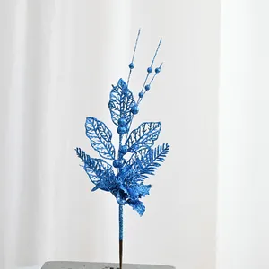 Blue glitter Christmas branch detail close-up artificial floral berry decoration for holiday tree.