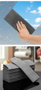 High-quality streak-free grey magic cleaning cloth for glass and mirrors shown in use