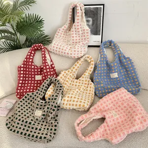 Detailed view of stylish waffle plush tote bags in various lovely colors displayed.