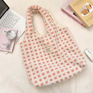 Detailed view of the cute pink plaid waffle fleece tote bag styled on a cozy aesthetic desktop.
